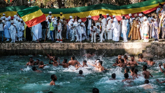 Ethiopian Orthodox worshippers at the compound of Fasilides Bath during the celebration of Timket, the Ethiopian Epiphany, in the city of Gondar, Ethiopia – 19 January 2022