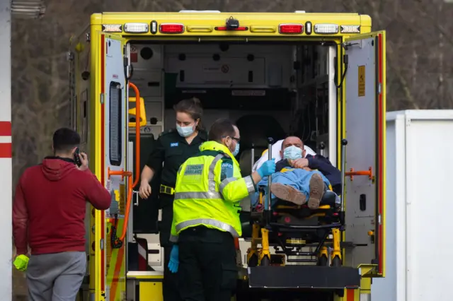 Ambulance, healthcare staff and patient wearing masks