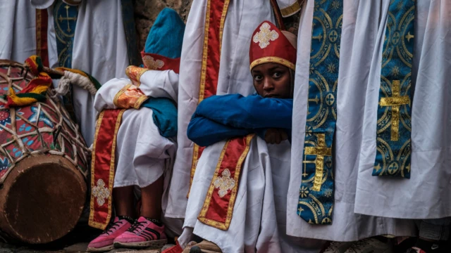 Ethiopian Orthodox worshippers at the compound of Fasilides Bath during the celebration of Timket, the Ethiopian Epiphany, in the city of Gondar, Ethiopia – 19 January 2022