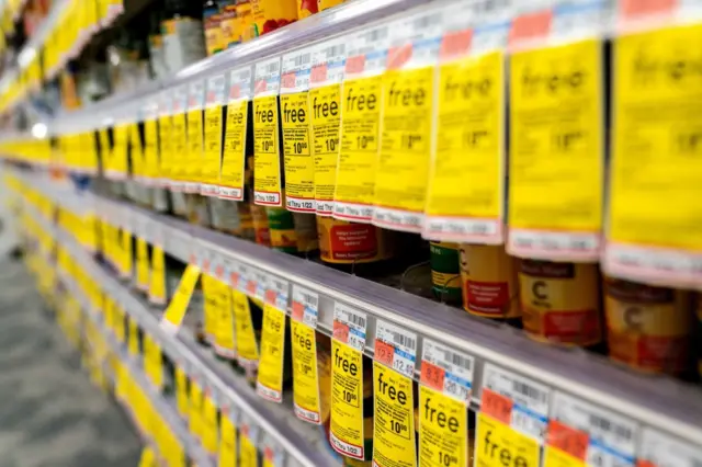 Sale stickers are displayed on shelves at a supermarket in Washington, DC