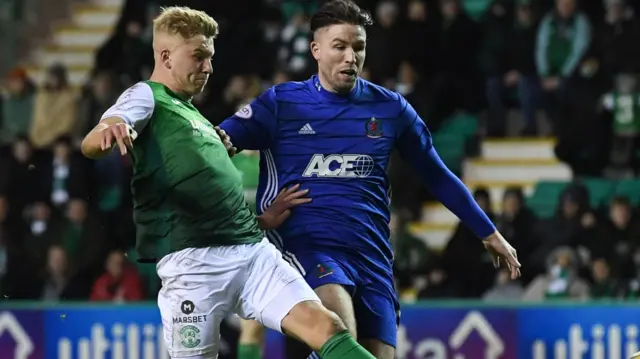 Hibs' Josh Doig has a shot under pressure from Cove Rangers' Morgyn Neill