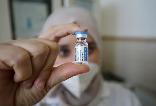 A medical worker prepares a dose of COVID-19 vaccine in Algiers, Algeria, January 17, 2022.