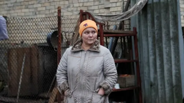 Maryna Serheyeva, 47, is seen near her house near the front line in the village of Zaitseve, in the Donetsk region