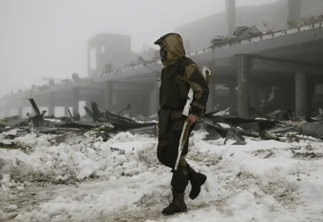 A Russian-backed rebel walks near the destroyed Donetsk airport, eastern Ukraine. Photo: January 2016