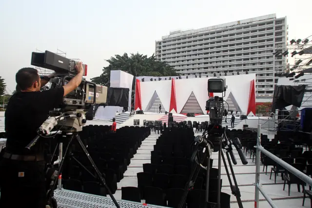 A technician works on a TV camera prior to the Kora music awards, in front of the Hotel Ivoire (Ivory Hotel) in Abidjan, on December 29, 2012