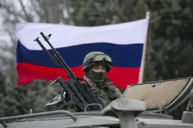 A Russian soldier sits in an armoured vehicle in Crimea, Ukraine. Photo: March 2014