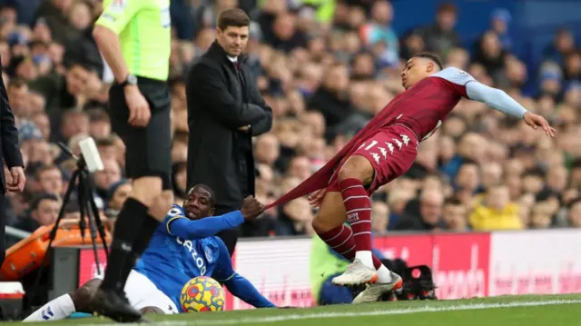 Abdoulaye Doucoure of Everton rips the shirt of Jacob Ramsey