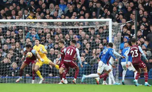 Emiliano Martinez and Tyrone Mings clear