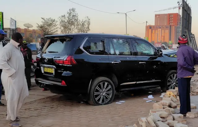 Bullet holes are seen in a car that belong to presidency following heavy gunfire near the President Roch Kaboré's residence in Ouagadougou, Burkina Faso, on 24 January.