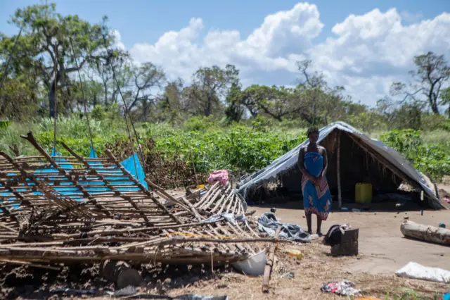 A woman stands next to the ruins of her house destroyed by cyclone Eloise in the Chinamaconde community of the Dondo district of Beira, northern Mozambique, January 28, 2021