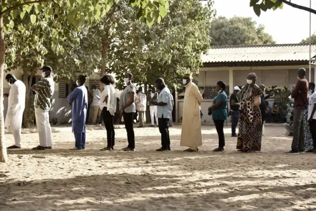 People queue at a polling station in Dakar on 23 January.