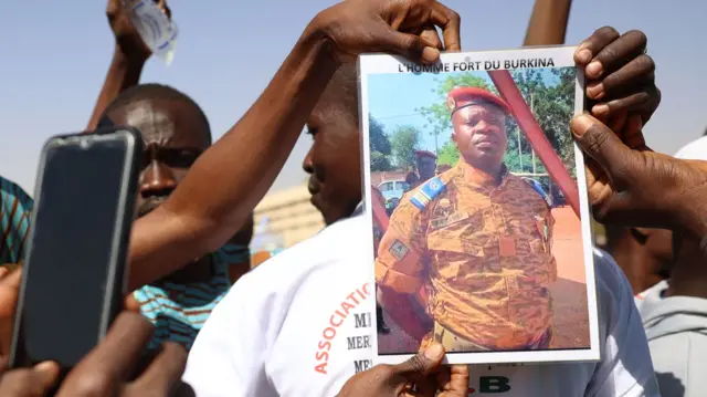 Demonstrators gathering in Ouagadougou to show support to the military hold a picture of Paul-Henri Sandaogo Damiba the leader of Burkina Faso's coup - 25 January 2022