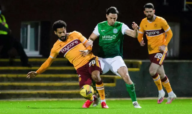 Jordan Roberts and Joe Newell battle for possession