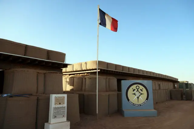 The French flag and France-led special operations logo for the new Task Force Takuba, a multinational military mission in sub-Saharan Africa's troubled Sahel region, with offices of European partners as Portugal, Belgium, Netherlands, Estonia and Denmark, at the Menaka base.