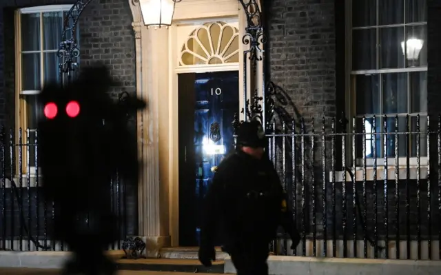 A police officer walks in front of10 Downing Street