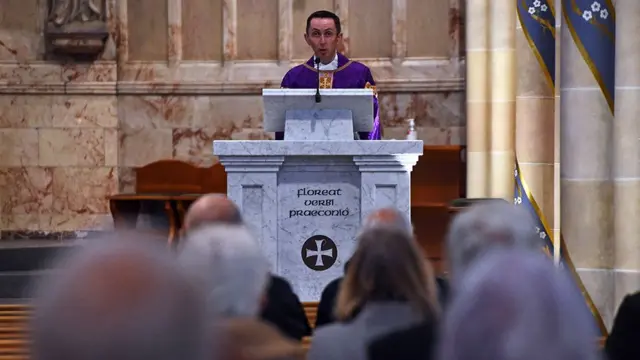 A priest giving a service in a church