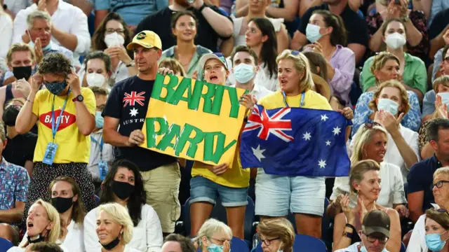 Fans hold up a sign reading 'Barty party'