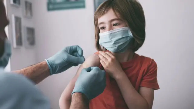 A child gets a Covid jab