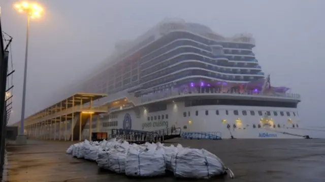 The German AIDAnova cruise ship docked in Lisbon's port as passengers prepare to disembark