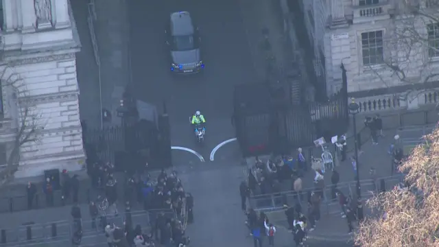 Aerial view of car leaving Downing Street