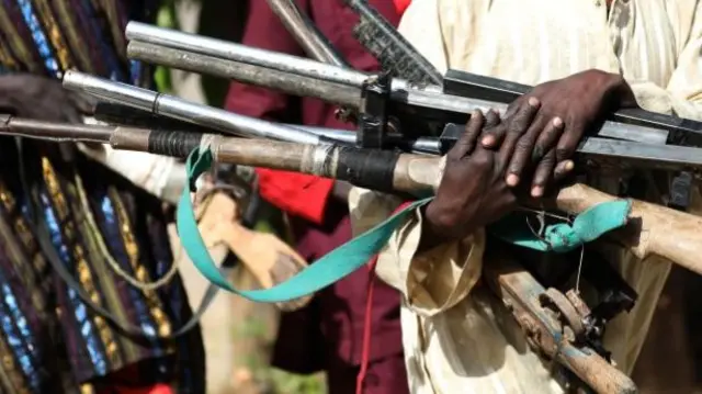 Man carrying guns