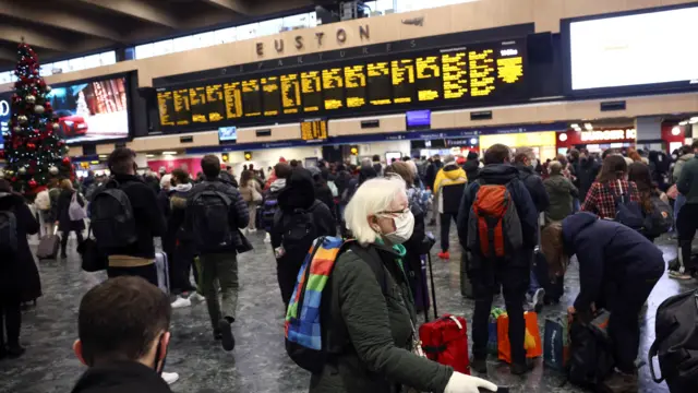 People walk through London Euston train station, amid the coronavirus disease (COVID-19) outbreak in London, Britain, December 23, 2021.