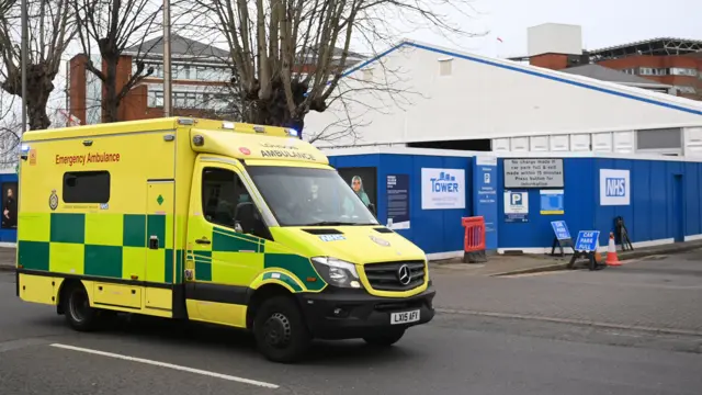 An ambulance passes a temporary "Nightingale" field hospital constructed in a car park of St. Georges Hospital in south London, Britain, 03 January 2022.