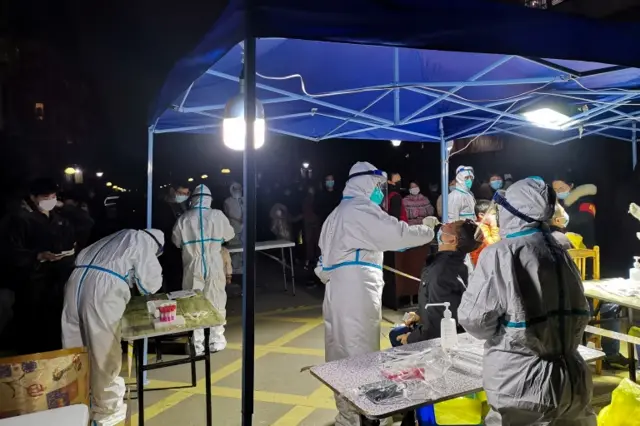 People line up for nucleic acid testing at a residential compound following new cases of the coronavirus disease in Ningbo, Zhejiang province, China, on 2 January 2022