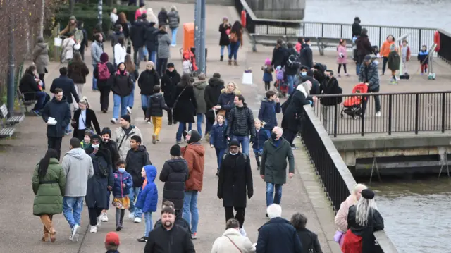 People walk along the Thames on a Bank Holiday in London, Britain, 03 January 2022. Britain"s Prime Minster Boris Johnson has declared the NHS and hospitals are going to face "considerable pressure" in coming weeks due to the Covid-19 cases surge.