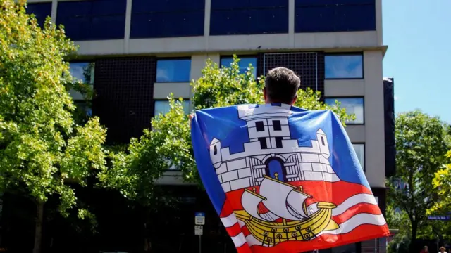 Djokovic's supporters have gathered outside the Melbourne hotel where he's rumoured to be temporarily held