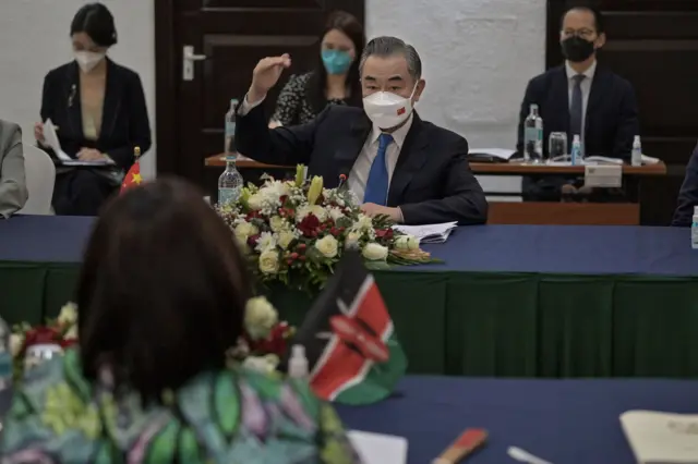 China's Foreign Minister Wang Yi (C) and his Kenyan counterpart, Raychelle Omamo (L) are seen during a bilateral meeting at the Sarova Whitesands Hotel when Kenyan and Chinese officials met in the Kenyan coastal city of Mombasa on January 6, 2022.