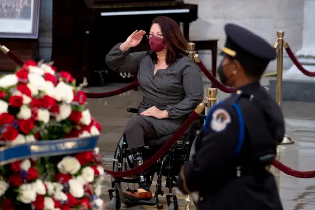 Duckworth, seen paying respects to a former Republican senator