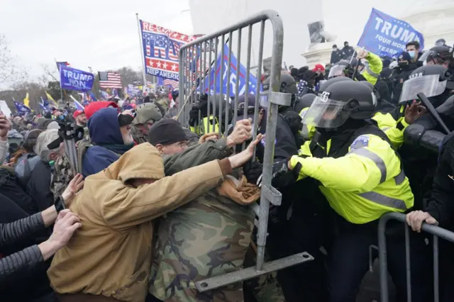 Pro-Trump protestors clash with police outside the Capitol building