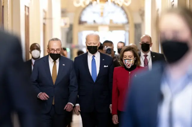 President Joe Biden (C), and Senate Majority Leader Chuck Schumer, a Democrat from New York (L), and U.S. House Speaker Nancy Pelosi, a Democrat