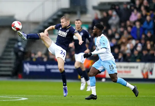 Millwall's Billy Mitchell (left) and Crystal Palace's Jeffrey Schlupp battle for the ball