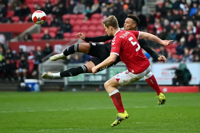 Rodrigo Muniz of Fulham has a shot on goal blocked by Rob Atkinson of Bristol City