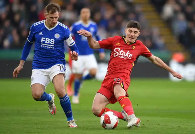 James Morris of Watford is challenged by Marc Albrighton of Leicester City