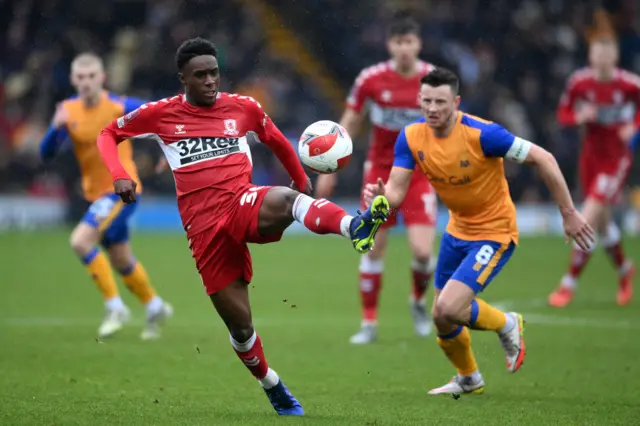 Williams Kokolo of Middlesborough controls the ball whilst under pressure from Ollie Clarke of Mansfield Town