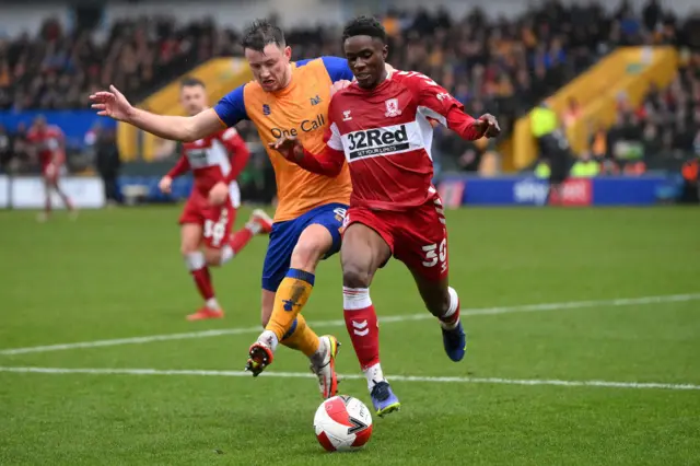 Williams Kokolo of Middlesborough battles for possession with Ollie Clarke of Mansfield Town