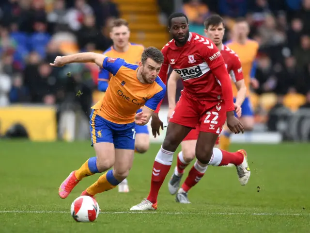 Rhys Oates of Mansfield Town battles for possession with Sol Bamba of Middlesborough