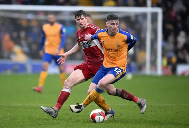 Oliver Hawkins of Mansfield Town battles for possession with Paddy McNair