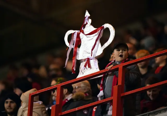 A fan holding up a tinfoil FA Cup