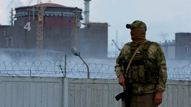 A Russian serviceman stands guard at the Zaporizhzhia nuclear power plant