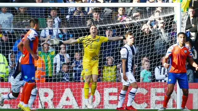 Steven Benda celebrates his penalty save