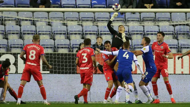 Thomas Kaminski punches the ball clear