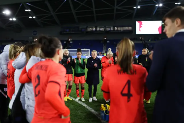 Sarina Wiegman huddles her players at full-time