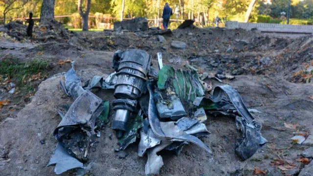 A missile debris seen next to a crater after a Russian missile attack on a children's playground in the center of the capital.