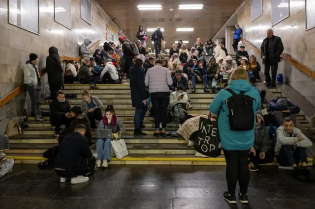 People shelter underground at a metro station in Kyiv
