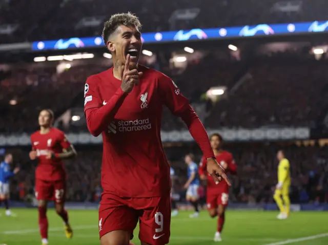 Roberto Firmino celebrates in front of the Liverpool fans at Ibrox