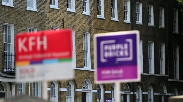 For sale signs outside homes